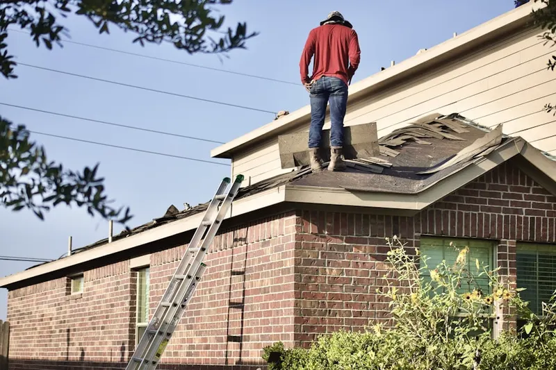 Professional roofer working on a residential roof in Clear Creek